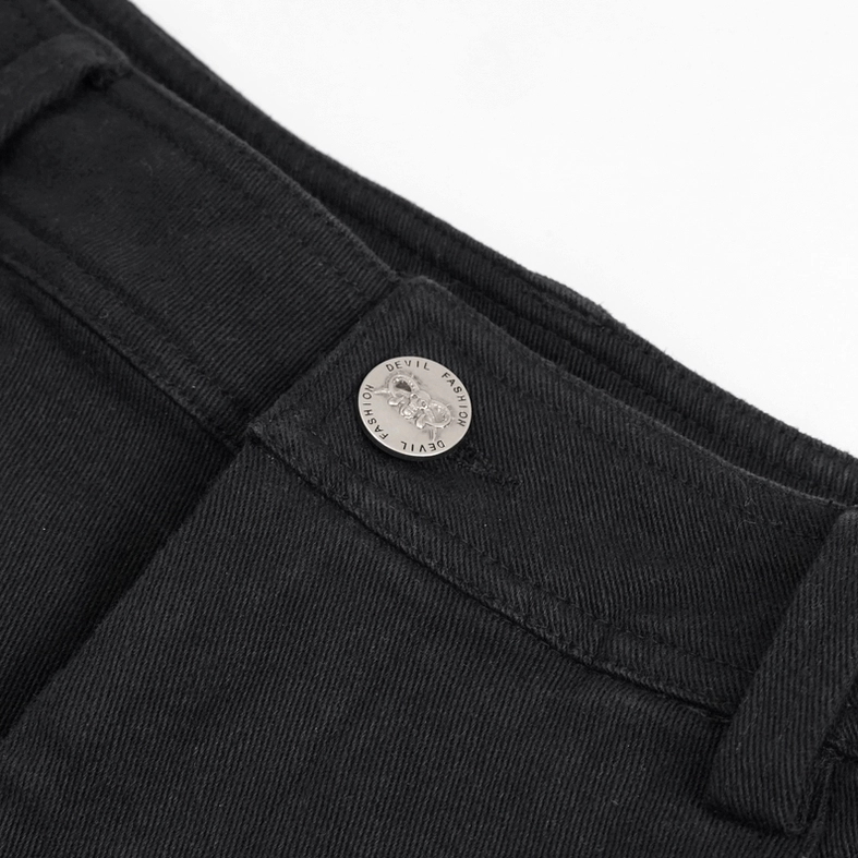 Close-up detail of gothic trousers waistband featuring metal button closure on black twill denim
