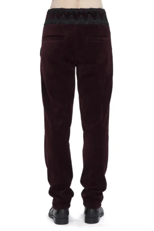 Black lace-trimmed wine red corduroy trousers rear view on male model, showing back pockets and lace waistband detail