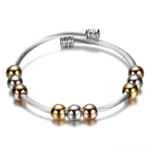 Two-tone gothic twist cuff bracelet with mixed metal beads flat lay overhead view