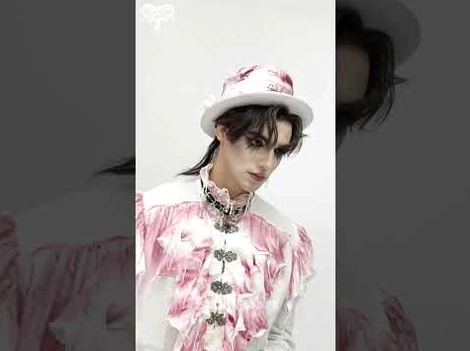 Male model wearing gothic ruffle shirt with high stand collar and gothic necklace close-up front view