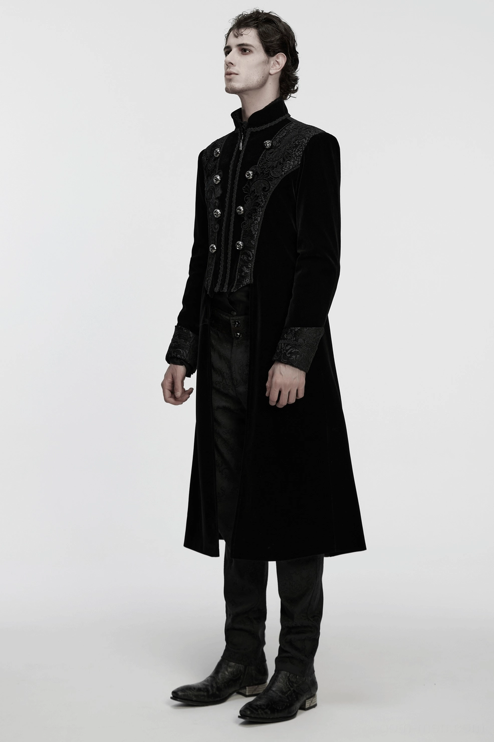Black velvet gothic coat overhead flat lay perspective revealing intricate palace jacquard patterns and coat construction