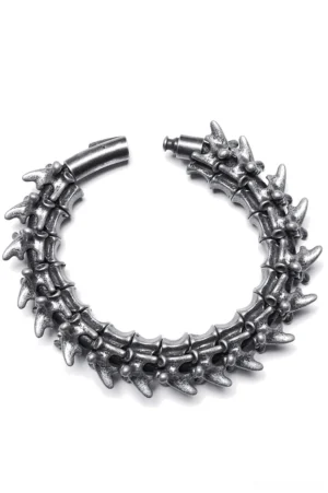 Vertebra spike metal gothic bracelet top-down view, aged dark silver finish with open clasp