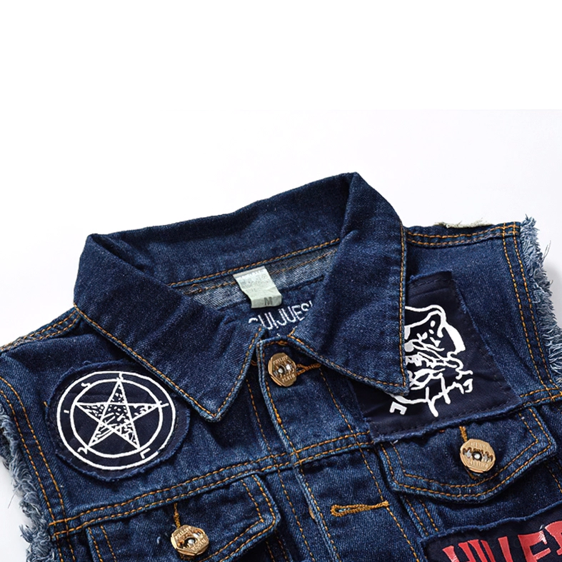 Close-up detail of blue denim gothic vest collar and upper front section showing pentagram patch, branded collar tag, and frayed denim edge texture