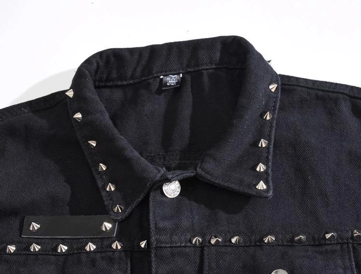 Top close-up view of gothic vest collar with cone spike studs and metal button