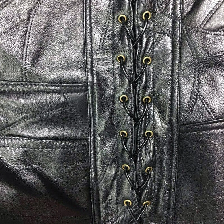 Embossed bison golden metal button close-up on gothic leather vest hardware