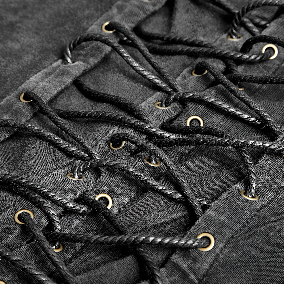 Close-up macro photograph of black gothic vest braided lace cord threading through metal eyelets, showing craftsmanship and lacing mechanism