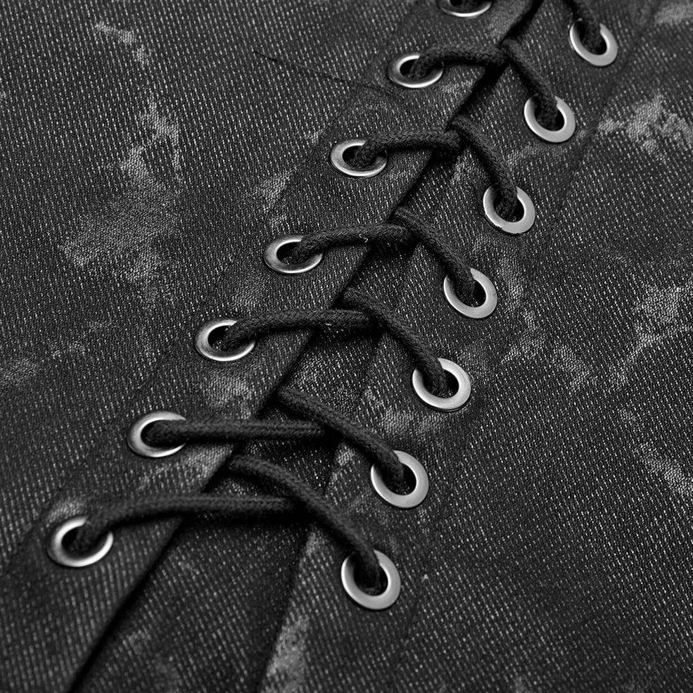 Black gothic vest lace-up detail close-up macro - metal eyelets and black lace cord on textured fabric