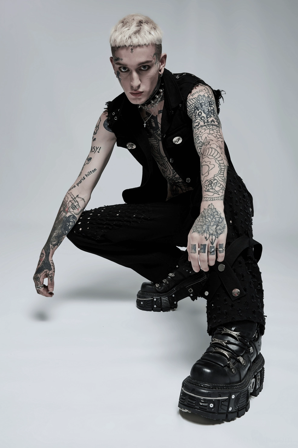 Lifestyle flat lay of black gothic studded vest in context showing texture details and construction quality
