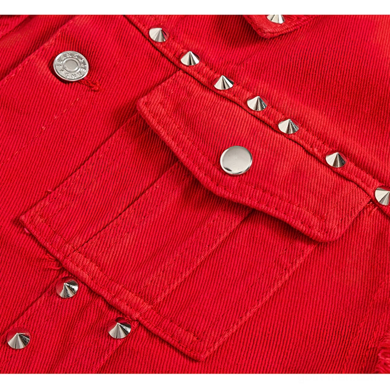 Close-up of red denim vest lower pocket trim with round metal snap button and linear silver cone studs
