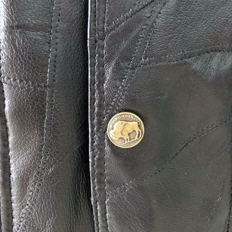 Layered front waist pockets detail of men's black patchwork leather gothic vest