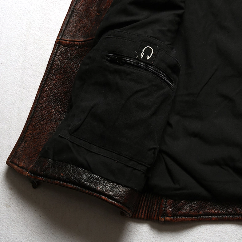 Close-up of inner zip pocket and headphone loop on gothic leather vest - functional design detail