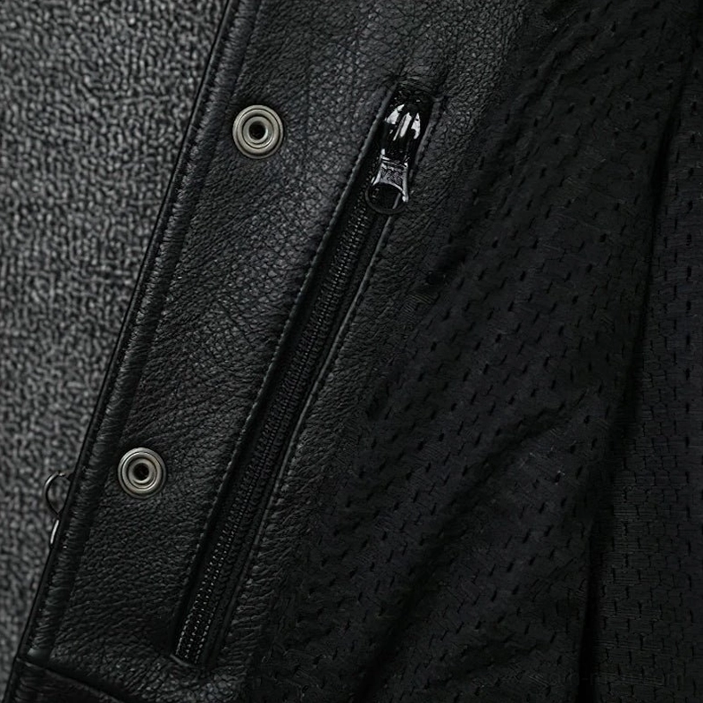Metal zipper pocket and snap fasteners on men's black leather gothic vest, close-up showing hardware and mesh interior lining