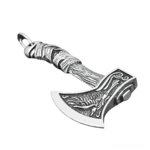 Antique silver gothic Viking axe pendant with intricate raven engraving and textured wrapped handle, shown at left oblique angle
