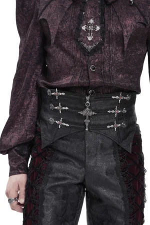 Male model wearing black brocade gothic waist corset with silver cross ornaments, front upper view, styled with dark purple gothic top in studio lighting