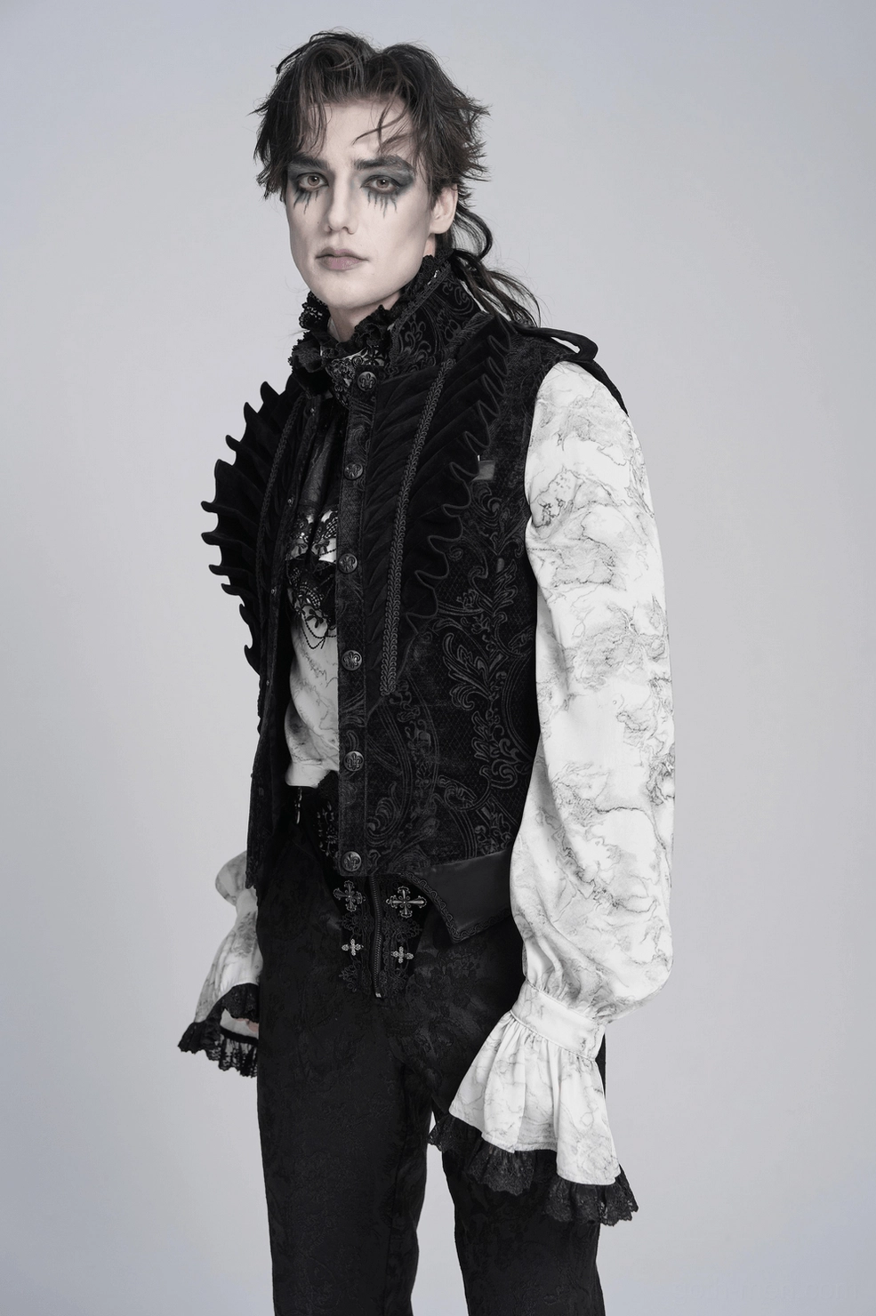 Back view detail of black gothic velvet waistcoat showing center seam, damask pattern, and buckle strap placement