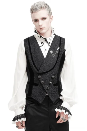 Black jacquard gothic waistcoat front view worn by model, double-breasted carved metal buttons, cross chain brooch detail, white studio background