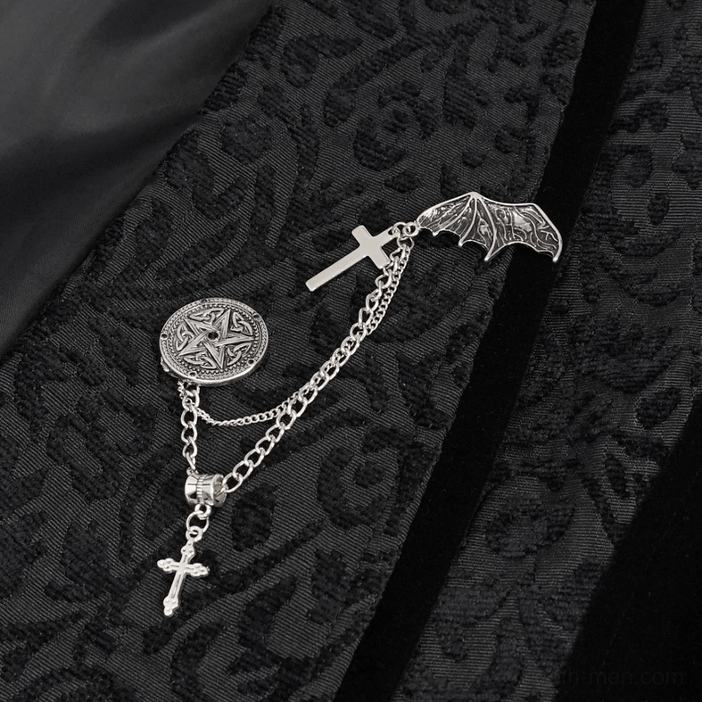 Close-up of black gothic waistcoat brooch featuring bat-cross chain decoration and pentagram pendant on jacquard fabric