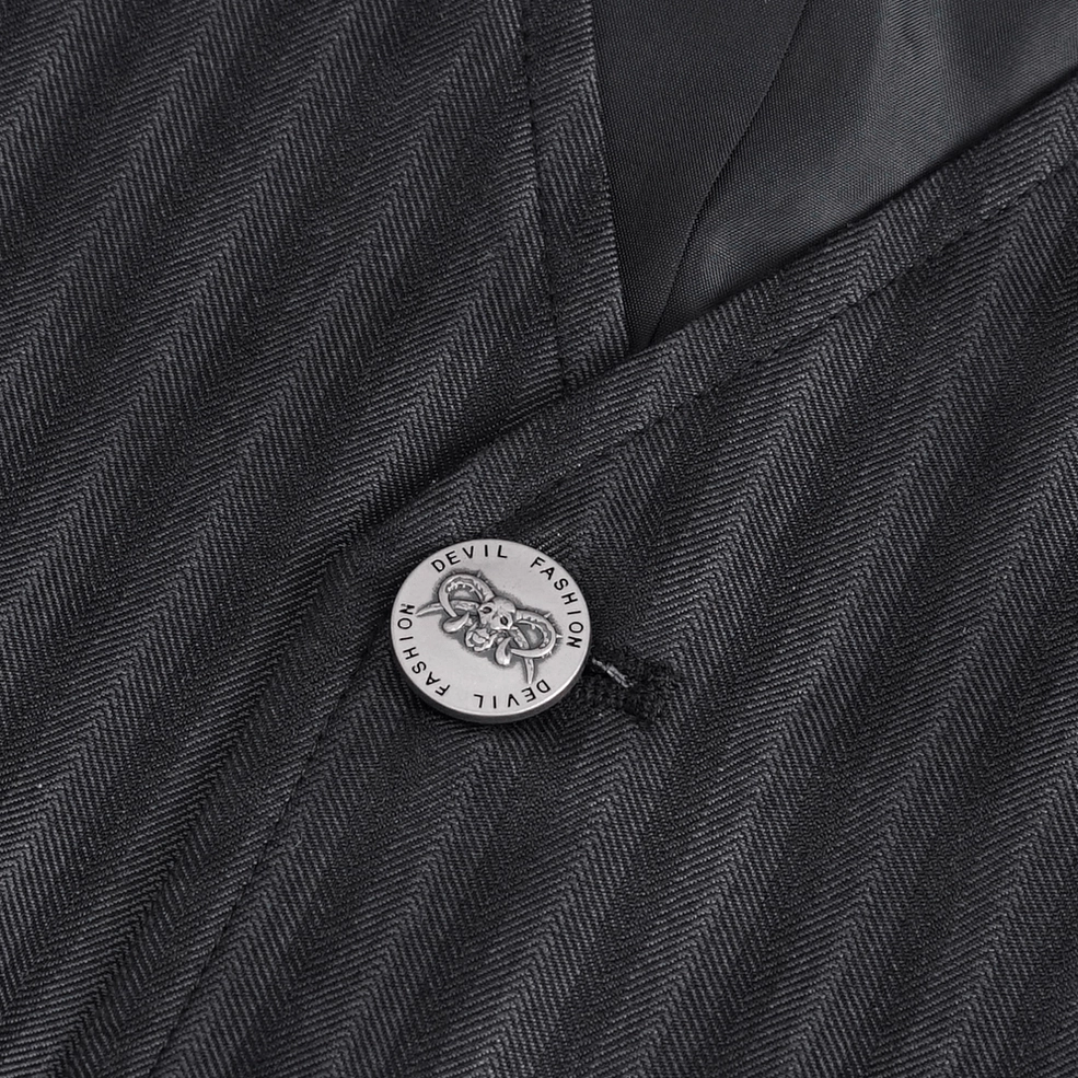 Gothic waistcoat button detail showing embossed branded metal button and pinstripe fabric