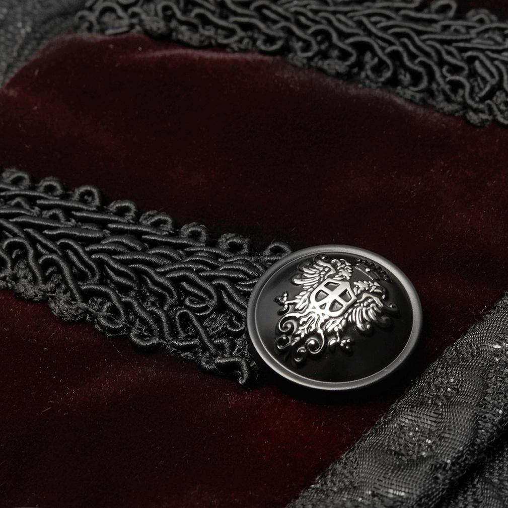 Close-up of embossed silver crest button with red velvet fabric and braided trim detail