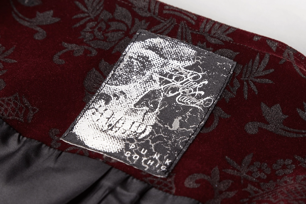 Close-up detail shot of gothic waistcoat showing damask velveteen fabric texture and brand tag