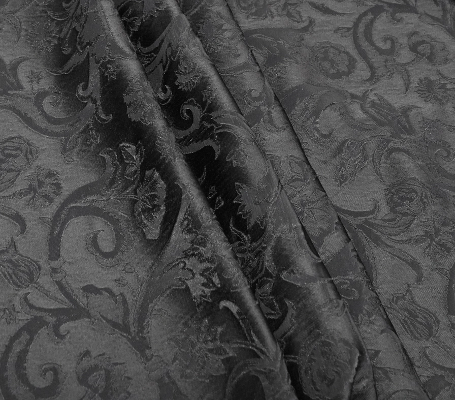 Black gothic corset waistcoat detail shot featuring embossed jacquard weave and red trim edges