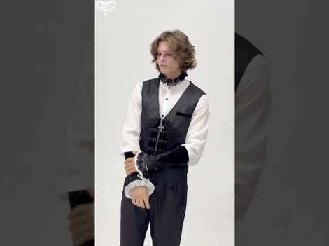 Gothic waistcoat styled with formal white ruffled shirt and goth accessories on model