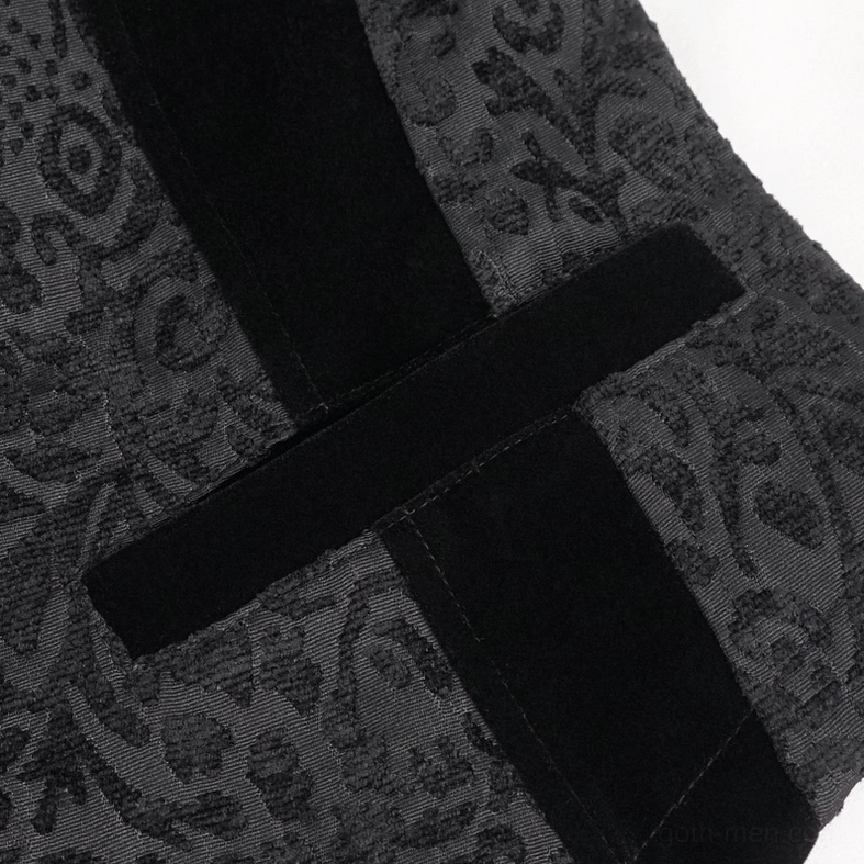 Black jacquard waistcoat fabric texture and velvet trim detail, showing raised weave pattern and material quality