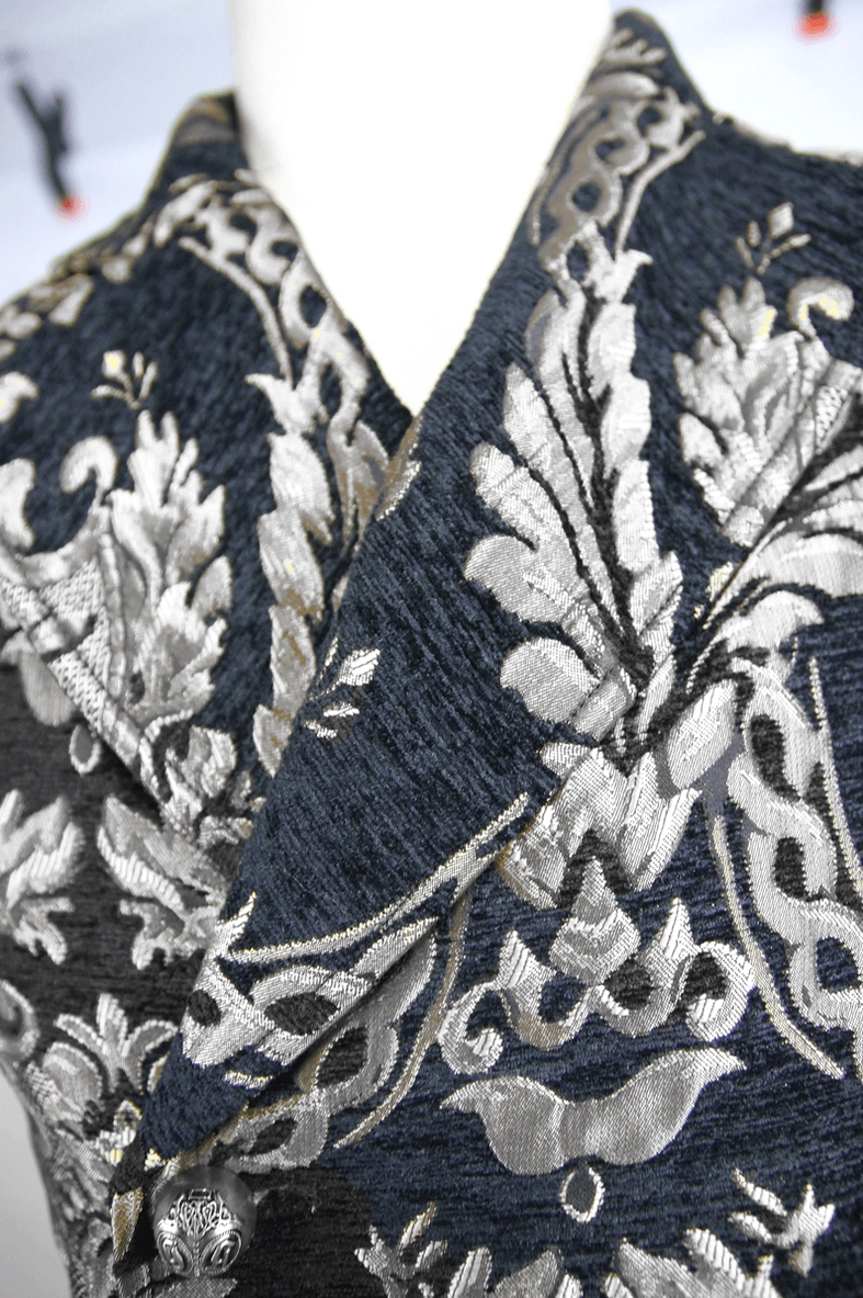 Close-up detail of gothic waistcoat peaked lapels and filigree texture