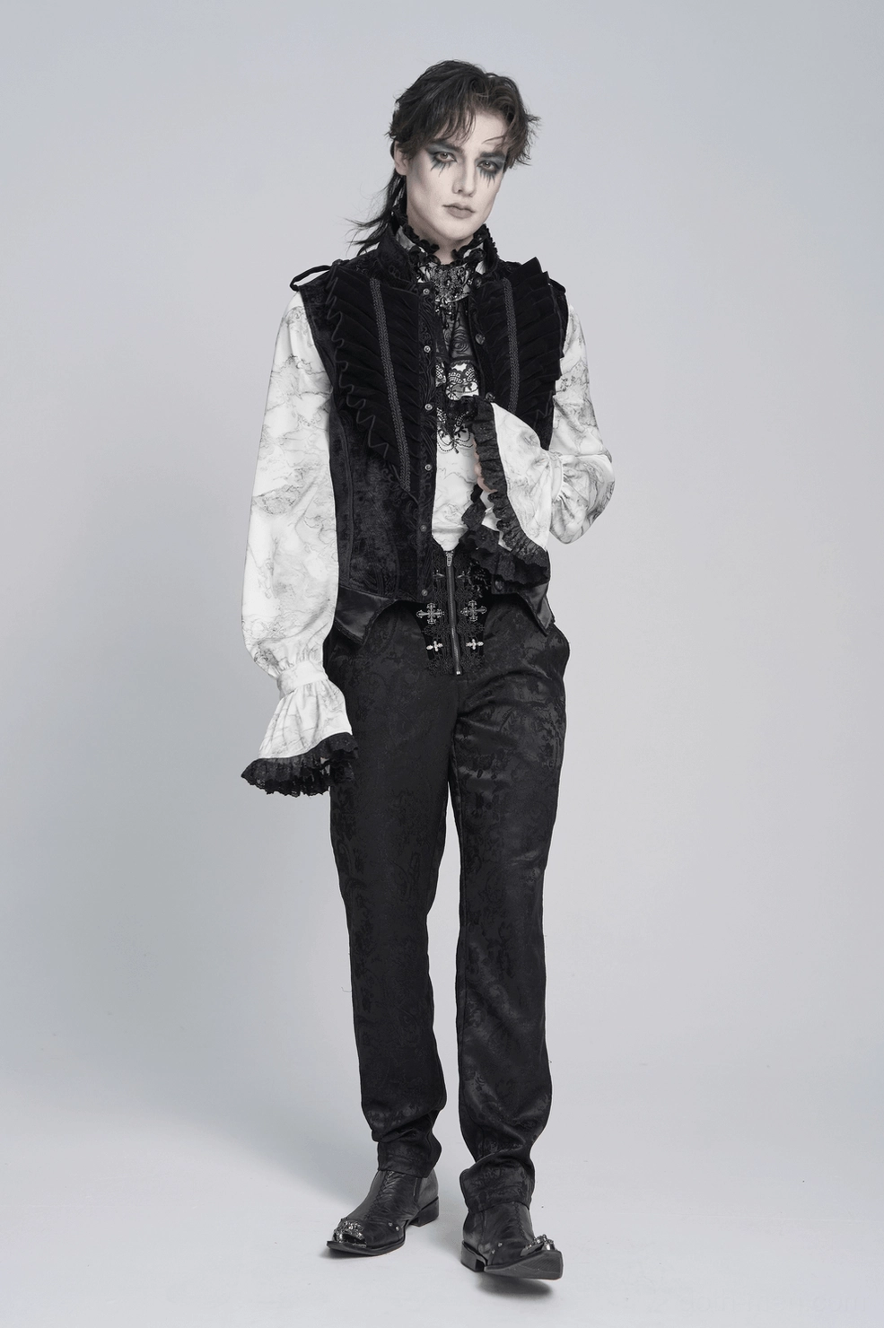 Left side view of gothic velvet waistcoat on model showing fit, damask texture, and leather buckle straps
