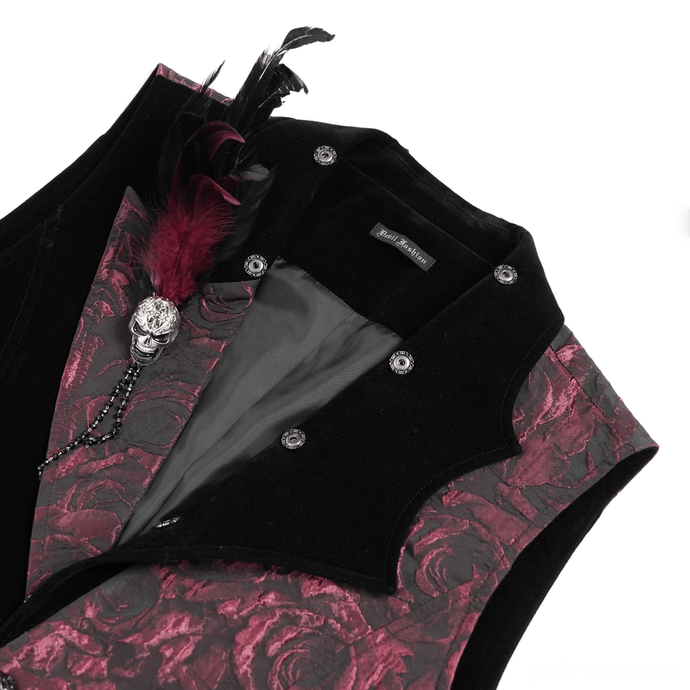 Close-up detail shot of skull brooch with decorative chain, maroon feather accent, velvet trim, and jacquard rose fabric on gothic waistcoat