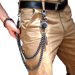 Gothic wallet chain with vintage silver layered curb links and bullet pendant, worn by male model on black jeans, front close-up view
