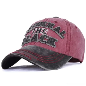 Washed gothic baseball cap with burgundy crown and dark grey contrast brim, featuring 3D embroidered letter logo detail