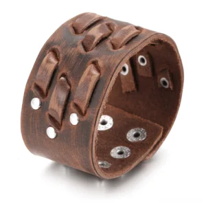 Wide brown leather gothic cuff bracelet with metal studs and rivets, studio view