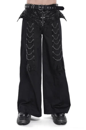 Black gothic wide leg pants with pyramid studs and draped metal chains - front full body view