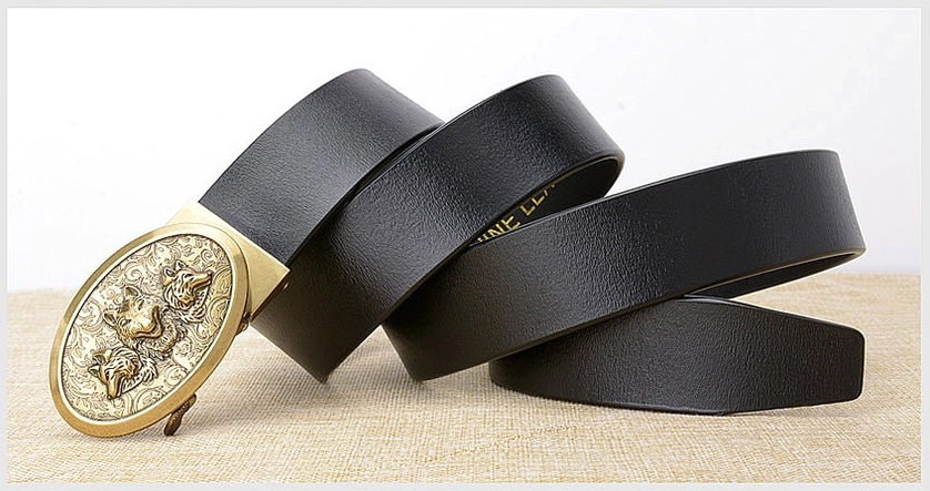 Black leather gothic belts with gold wolf buckles, stacked arrangement on linen, collection presentation