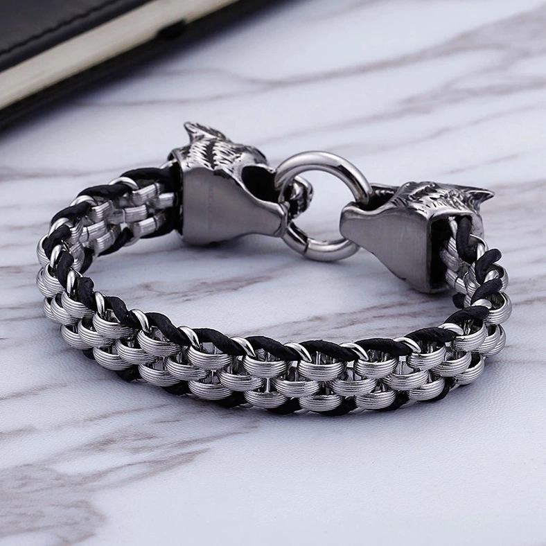 Stainless steel and cowhide leather wolf head bracelet front flat lay on marble showing double wolf clasp mechanism