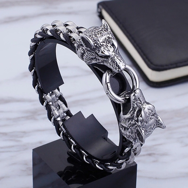 Alternative men's wolf head bracelet three-quarter side view on display stand with marble background revealing black cowhide leather interior