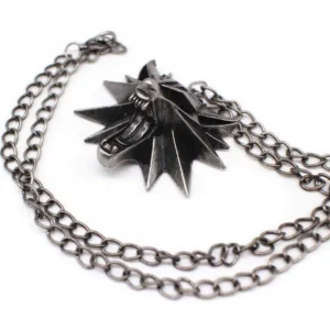 Gothic wolf head pendant necklace with antique silver finish and intricate detailed carving, displayed at overhead angle on white background