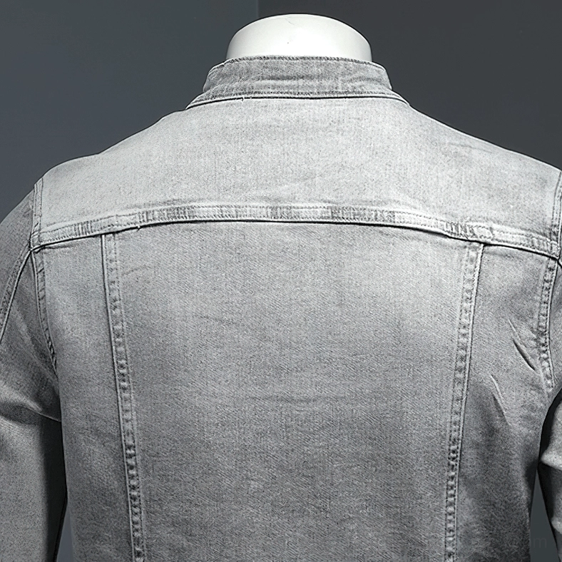 Back denim seams and yoke design detail of gray stand collar jacket with washed fabric texture