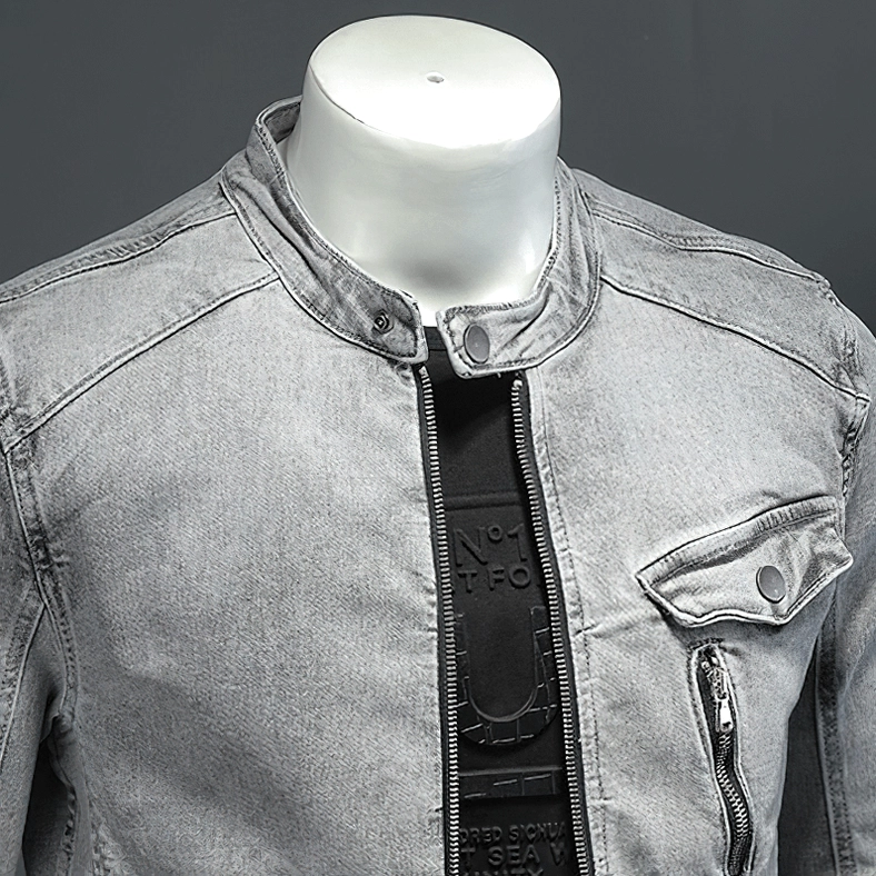 Close-up detail of gray denim jacket stand collar snap button and chest pocket hardware