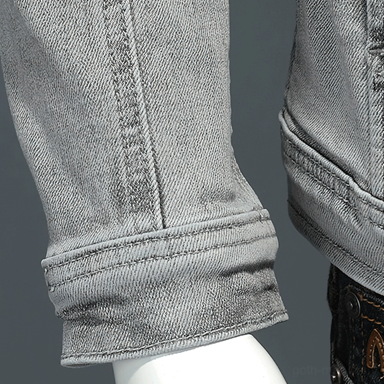 Gray denim jacket cuff and sleeve hem detail showing reinforced stitching and ribbed finish