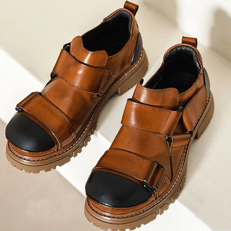 Distressed gray gothic platform loafers with black toe box and deep lug sole pattern, detail view