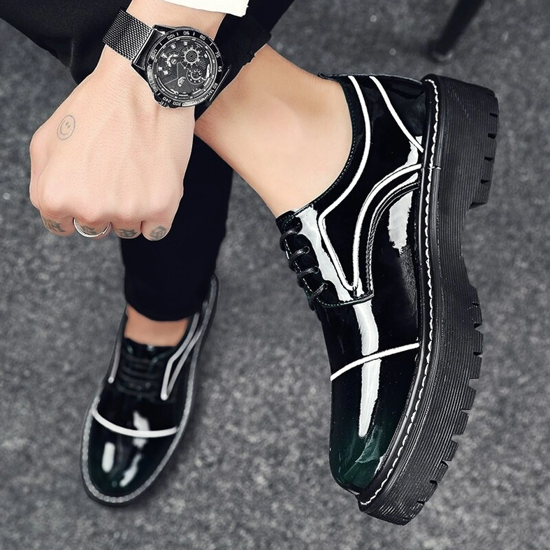 Men's dark green glossy oxford platform shoes close-up side view with visible wristwatch accessory