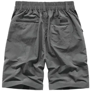 Grey tactical cargo shorts rear view showing elastic waistband and zippered back pockets for secure storage