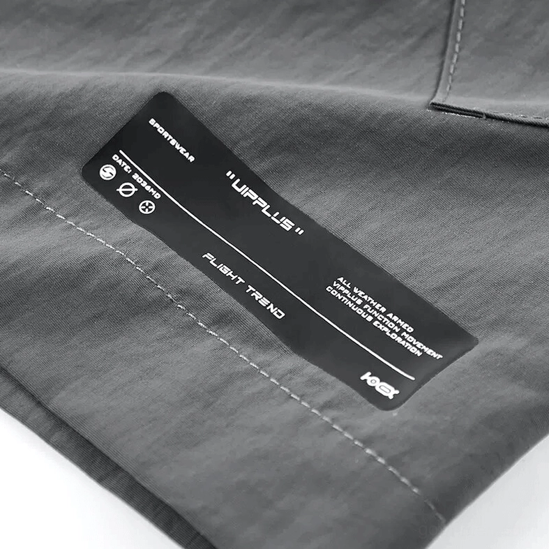 Grey tactical cargo shorts lifestyle flat lay showcasing utility pockets, adjustable waist system, and industrial goth aesthetic