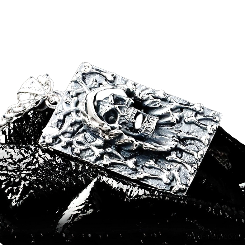 Silver grim reaper pendant with attached wheat chain, side profile view showing depth of bone relief carving