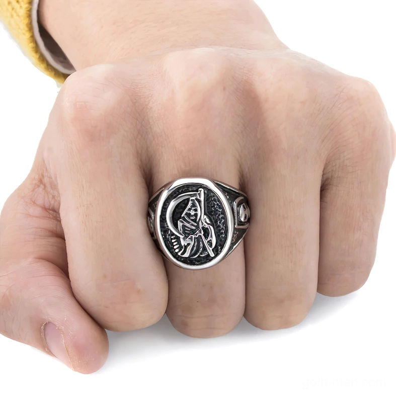 Male hand wearing memento mori gothic reaper ring on middle finger showing fit and wearing effect