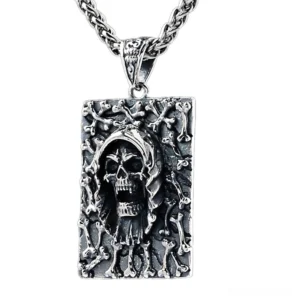 Sterling silver grim reaper skull pendant with bone relief frame, vintage oxidized finish on white background, front flat view