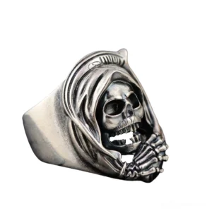 Grim Reaper skull ring with hooded death figure, left three-quarter view showing aged dark silver finish and skeletal hand carving