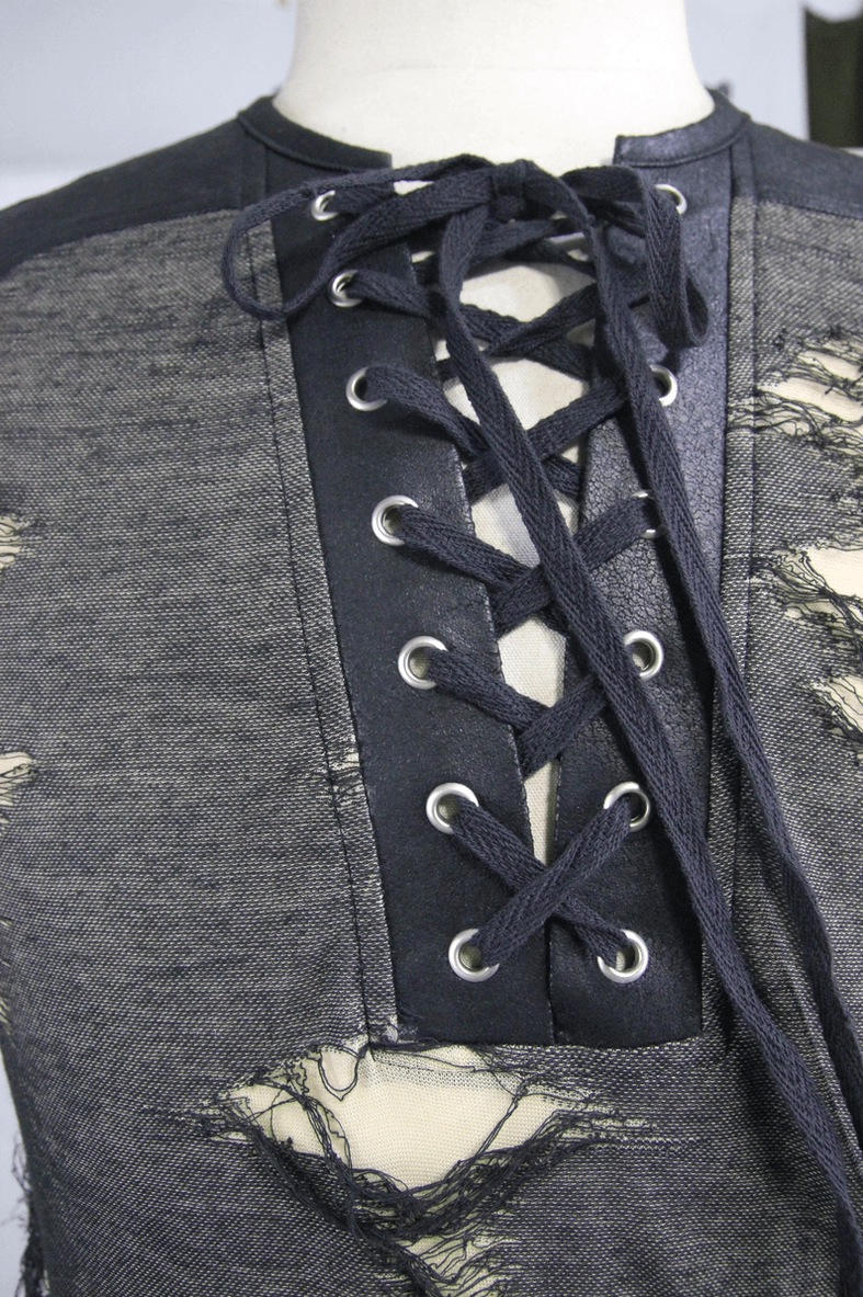 Male model wearing dark gray grunge tank top with layered alternative fashion styling